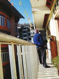 Full length of woman standing by railing