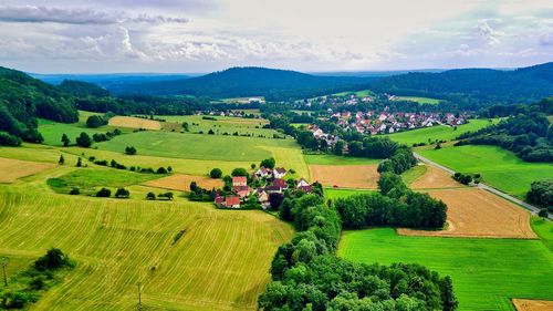 Scenic view of agricultural field against sky