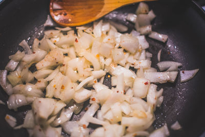 Close-up of chopped onions in cooking pan