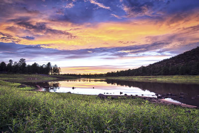 Scenic view of lake against sky during sunset