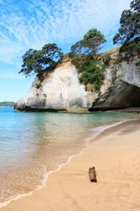 Scenic view of rocks on beach against sky