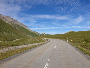 Empty road along countryside landscape