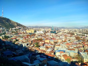 High angle view of townscape against blue sky