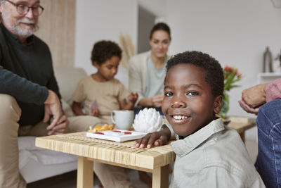 Family relaxing and playing games at home