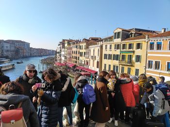 Group of people against buildings in city