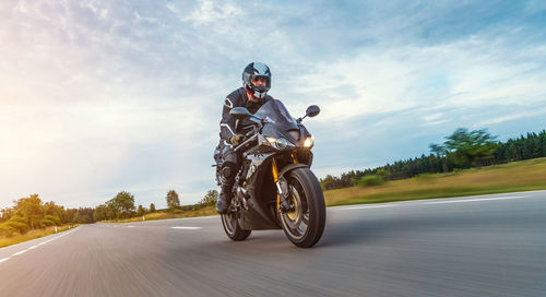 Man riding motorcycle on road