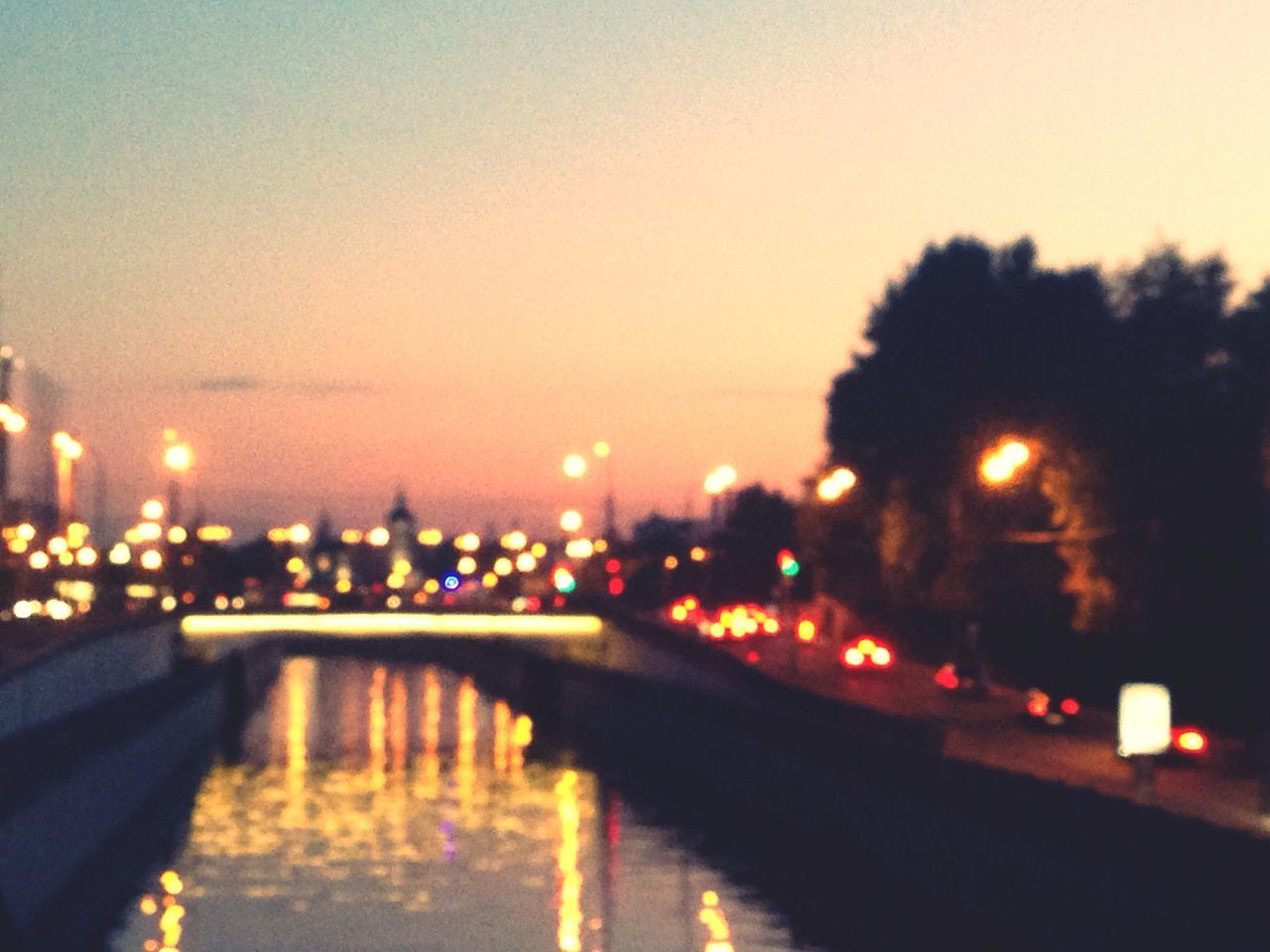 illuminated, night, water, architecture, building exterior, built structure, reflection, clear sky, city, river, lighting equipment, street light, waterfront, copy space, sky, bridge - man made structure, outdoors, no people, cityscape, glowing