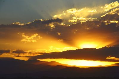 Scenic view of silhouette mountains against sky during sunset