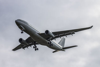 Low angle view of airplane flying against sky