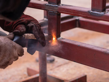 Cropped image of manual worker welding railing