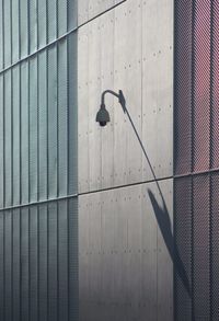 Low angle view of street light against wall