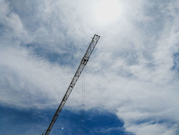 Low angle view of crane against sky