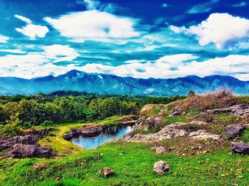 Scenic view of river and mountains against sky