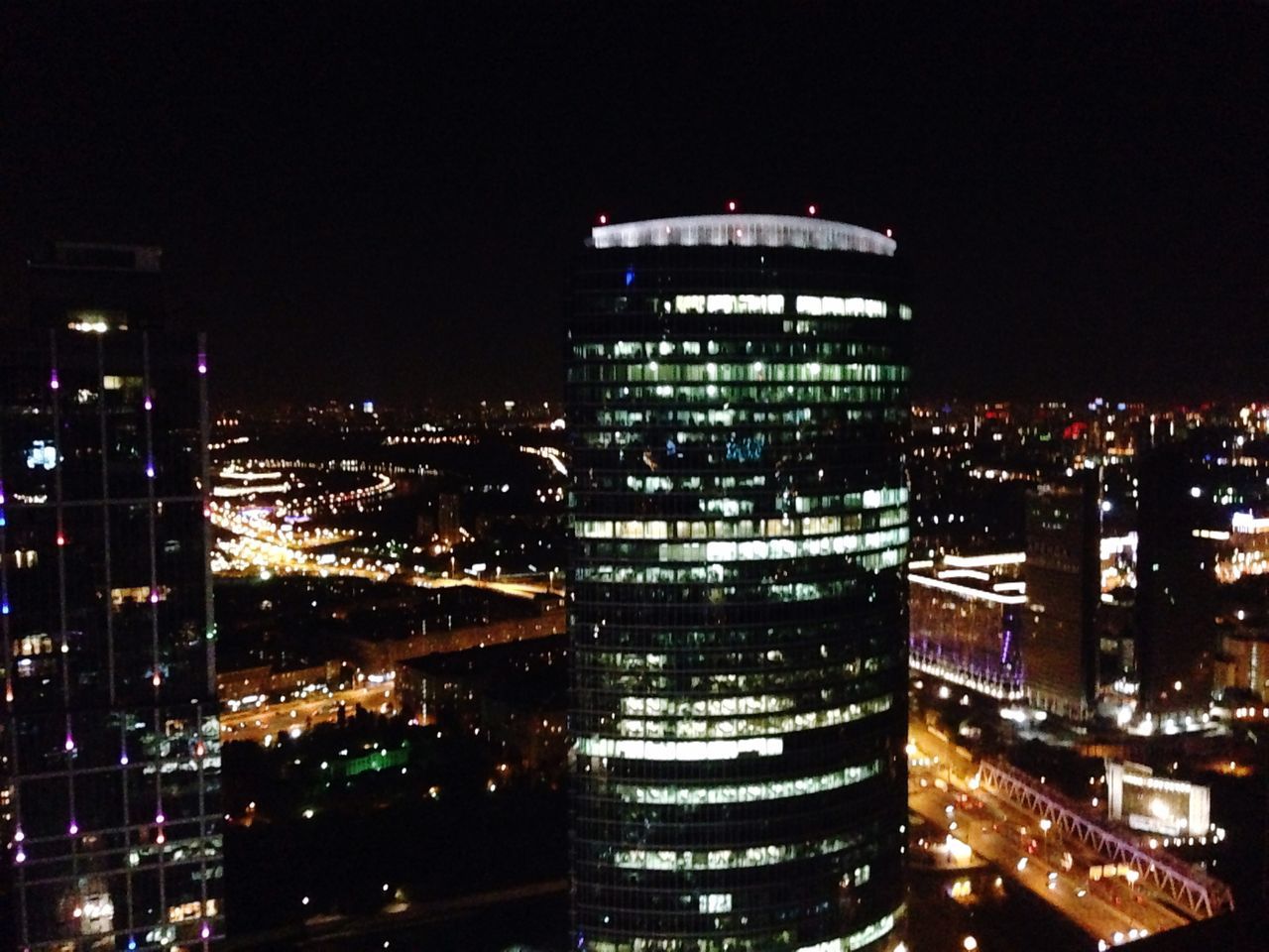 illuminated, night, architecture, building exterior, built structure, city, skyscraper, modern, cityscape, tower, office building, tall - high, capital cities, city life, travel destinations, building, financial district, no people, clear sky, sky