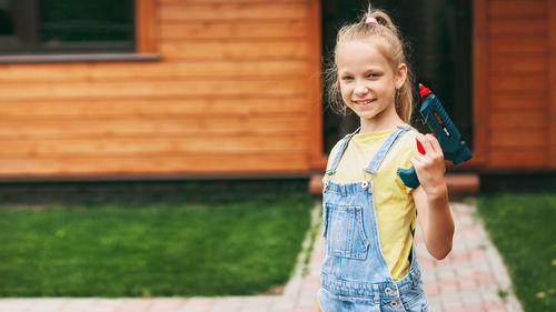 Portrait of smiling girl standing outdoors