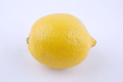 Close-up of orange apple against white background