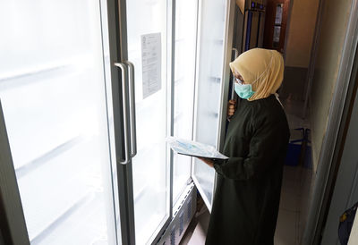 Health worker in the cold room for the covid-19 vaccine at one of the hospitals