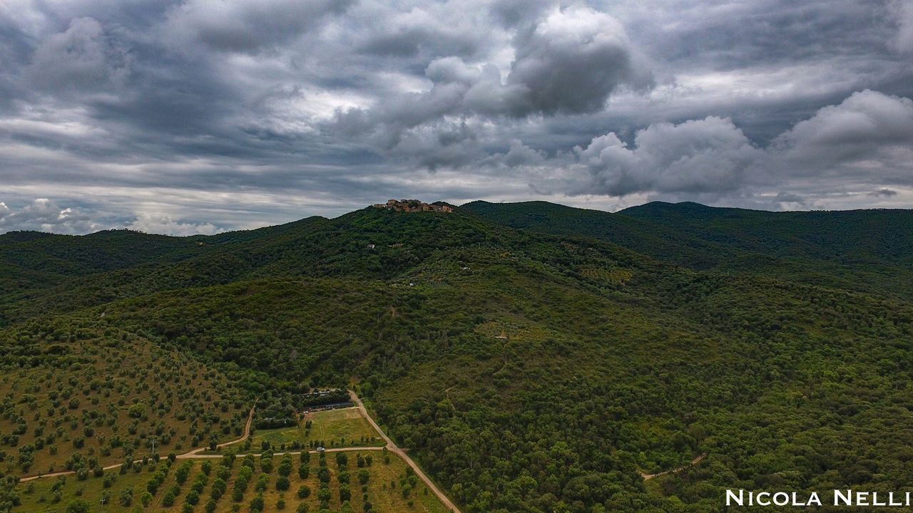 SCENIC VIEW OF MOUNTAINS AGAINST CLOUDY SKY