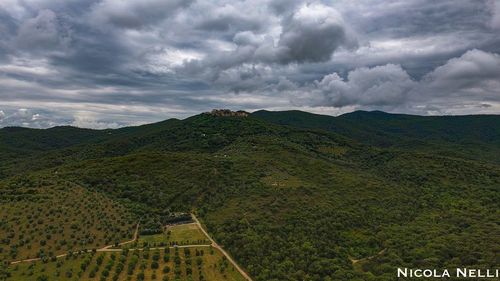 Scenic view of mountains against cloudy sky