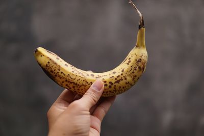 Cropped hand of woman holding banana