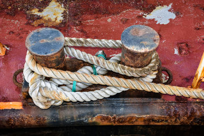 High angle view of ropes tied on bollard