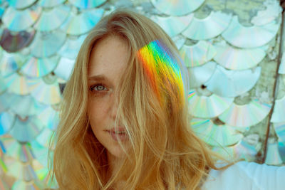 Close-up portrait of woman with light on hair