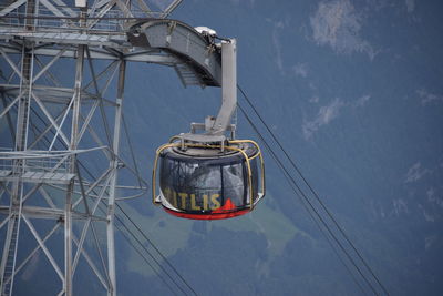 Low angle view of overhead cable car against sky