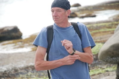 Senior man standing at beach