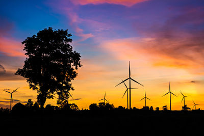 Silhouette of wind turbines at sunset