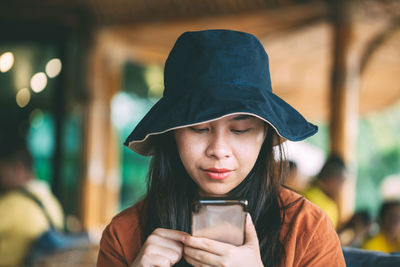 Portrait of young woman looking away outdoors