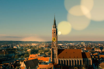 Aerial view of city lit up at sunset