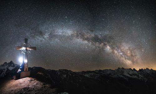 Scenic view of illuminated mountains against sky at night