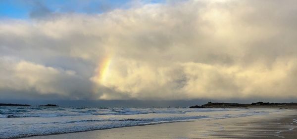 Scenic view of sea against storm clouds