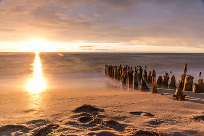 Scenic view of beach against sky during sunset