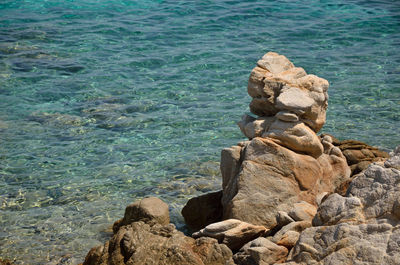 Handmade rocky tower by the blue sea in greece