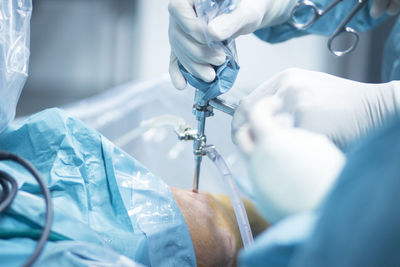 Cropped image of doctors operating patient in hospital