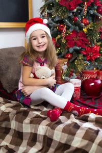 Portrait of happy girl in christmas tree