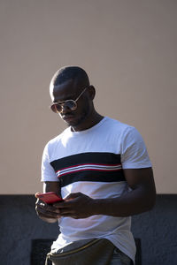 Man with sunglasses using mobile cell phone.