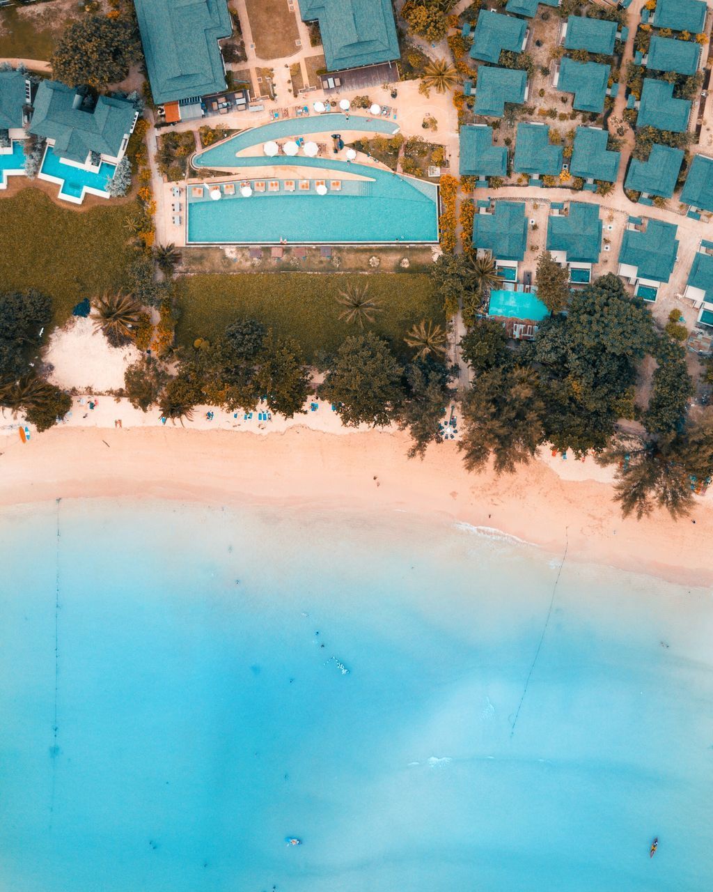 HIGH ANGLE VIEW OF BUILDINGS BY SWIMMING POOL