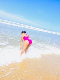 Full length of woman on beach against sky