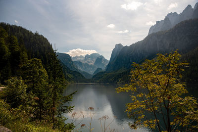 Scenic view of river amidst mountains against sky