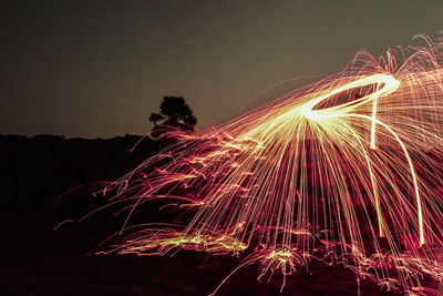 Low angle view of firework display at night