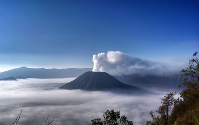 Scenic view of clouds covering mountain