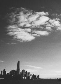 View of cityscape against cloudy sky