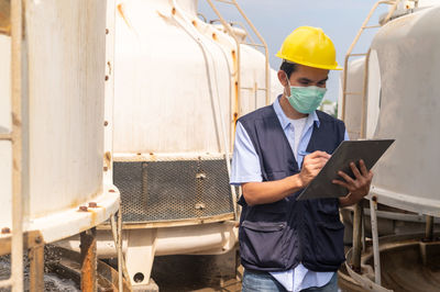 Portrait of young man working in factory