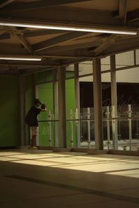 Side view of man standing in building