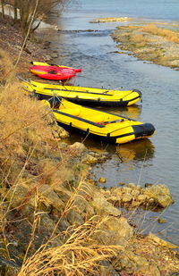 Yellow boat moored on beach