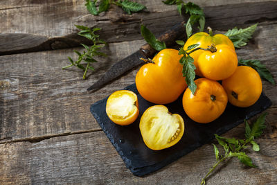 High angle view of fruits and leaves on table