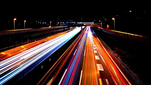 High angle view of light trails on highway at night