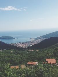 Scenic view of sea and mountains against sky